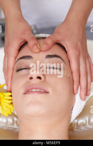 Female Enjoying Relaxing face Massage In Cosmetology Spa Center Stock Photo