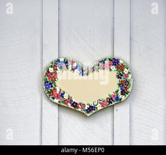 Wooden heart with painted flowersr Stock Photo