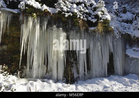 Frozen icicles on a road Stock Photo
