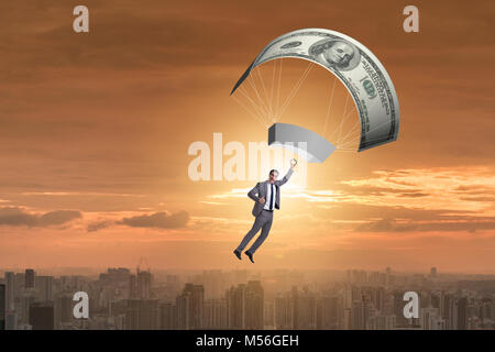 Businessman in golden parachute concept Stock Photo