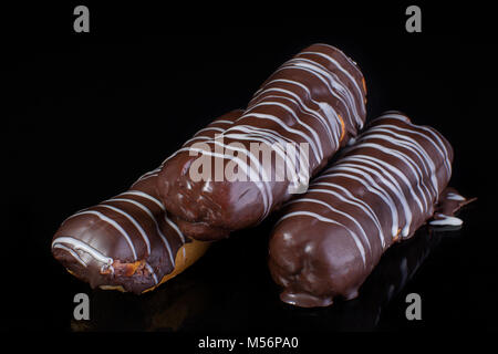 Cake chocolate eclairs on a dark background close up Stock Photo