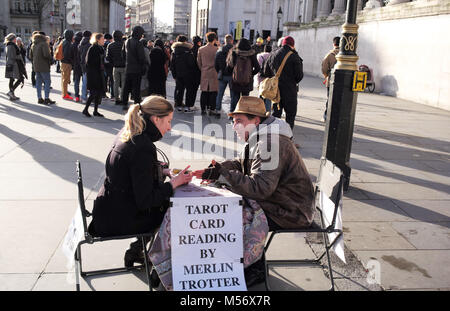 Merlin Trotter tarot card reader reads a young lady cards on the street in London. Stock Photo