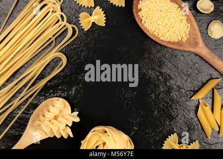 Overhead photo of different types of pasta on black Stock Photo