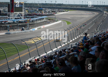 Car racing. International speedway. View from the tribune of the stadium on the funs and racing cars close up in the time of the competition. Speedway Stock Photo