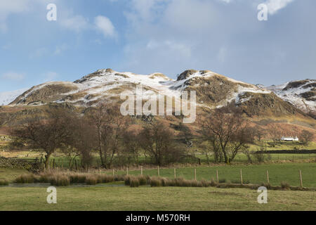 The Lake District, Cumbria, in winter with snow on the tops. High Rigg looms above the Naddle Valley, viewed from close to Dale Bottom Stock Photo