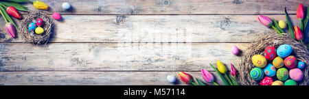 Tulips And Painted Eggs In Nests On Vintage Plank Stock Photo