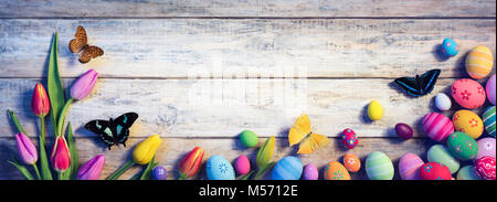 Easter - Tulips With Butterflies And Painted Eggs On Vintage Plank Stock Photo