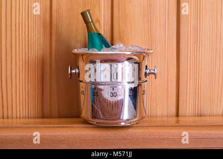 Kitchen timer shaped like champagne bottle and bucket on a wood background Stock Photo