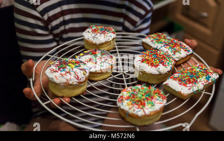 Little Easter cakes in children's hands, life style. Stock Photo