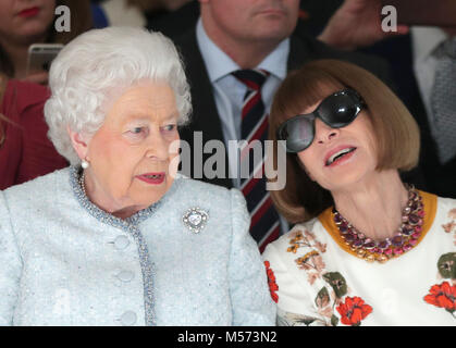 Queen Elizabeth II sits next to Anna Wintour (right) as they view Richard Quinn's runway show before presenting him with the inaugural Queen Elizabeth II Award for British Design as she visits London Fashion Week's BFC Show Space in central London. Stock Photo