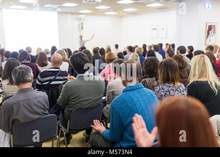 Woman giving interactive motivational speech at entrepreneurship workshop. Stock Photo