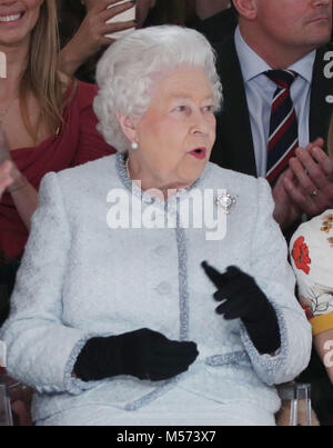 Queen Elizabeth II reacts as she views Richard Quinn's runway show before presenting him with the inaugural Queen Elizabeth II Award for British Design as she visits London Fashion Week's BFC Show Space in central London. Stock Photo