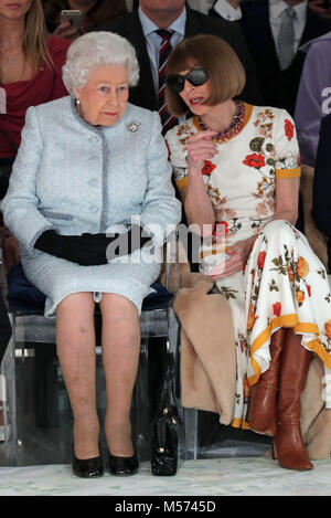 Queen Elizabeth II sits next to Anna Wintour (right) as they view Richard Quinn's runway show before presenting him with the inaugural Queen Elizabeth II Award for British Design as she visits London Fashion Week's BFC Show Space in central London. Stock Photo