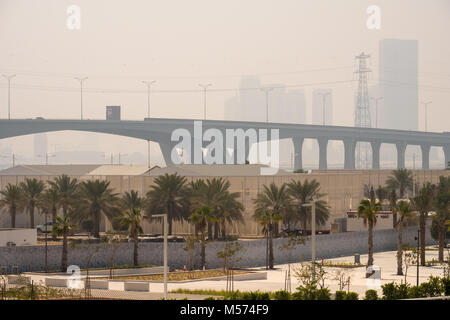 Abu Dhabi city drowned in smog at sunset, Sheikh Khalifa Bridge and City in a Dusk Stock Photo