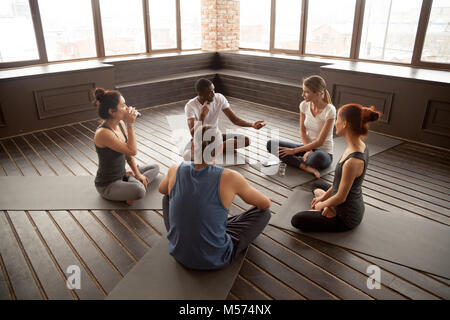 Meditation Session. Group Of Diverse Sporty People Practicing Yoga In  Modern Gym Stock Photo - Alamy