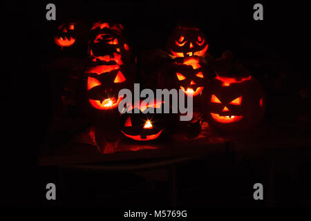 pumpkin-jack, terrible, eerie, night, black, shine, lamp, candle, red background, in the dark, carved from a pumpkin, evening, celebration, fun, laugh Stock Photo