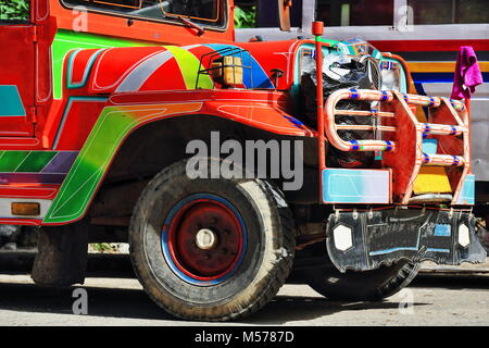 Filipino orange-red dyipni-jeepney car. Public transportation in Sagada town-originally made from US.military jeeps left over from WW.II locally alter Stock Photo