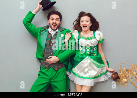 Young couple in festive costumes saint patrick's day top view looking camera surprised Stock Photo
