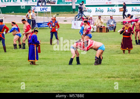 Ulaanbaatar, Mongolia - July 11, 2010: Wrestlers compete during Nadaam, Mongolia's most important festival. Roots lie in Mongolian warrior traditions. Stock Photo