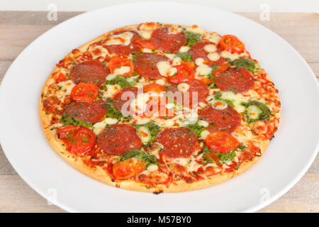 Pizza with pesto and salami Stock Photo
