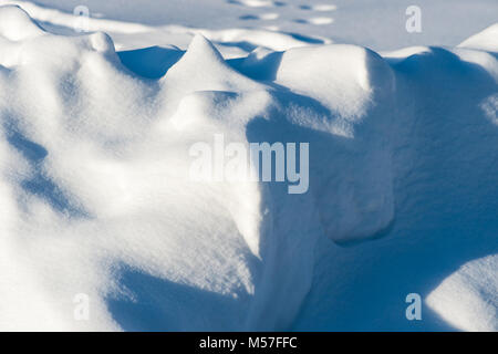 Layer of pure fresh snow. Play of light and shadow. Cold winter and Christmas holidays season. Pattern or background Stock Photo