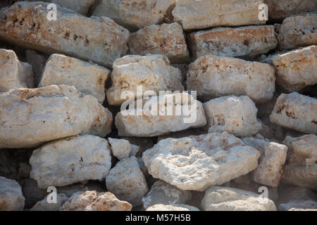 stone wall,Natural stone background. Rustic old wall wallpaper. Rough grey stone bricks design. Ancient masonry wall big rocks. Rustic weathered stone Stock Photo