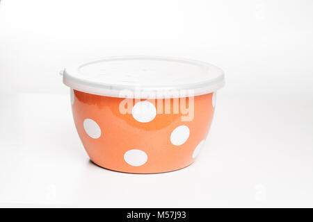 orange stainless cups with lids set of metal containers for storing foods with plastic caps steel bowls isolated steel bowls on the white. Stock Photo