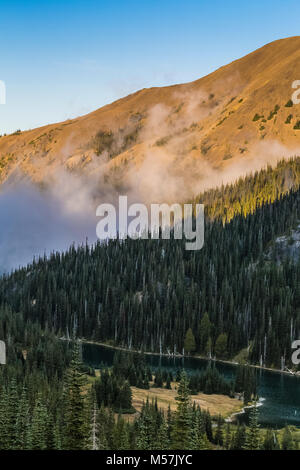 Low clouds hanging over Moose Lake in Grand Valley in evening, Olympic National Park, Washington State, USA Stock Photo