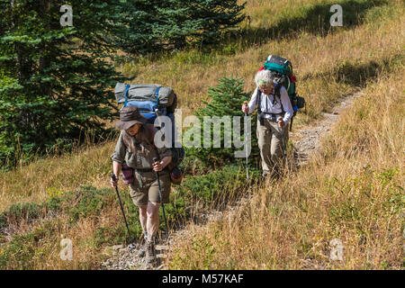 Backpackers Karen Rentz and Joan Michaels on Grand Pass Trail during a backpacking trip into Grand Valley in Olympic National Park, Washington State,  Stock Photo