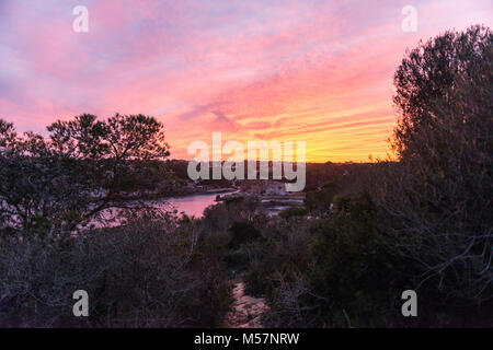 View of a colorful sunset over Cala Llombards in Mallorca, Spain. Stock Photo