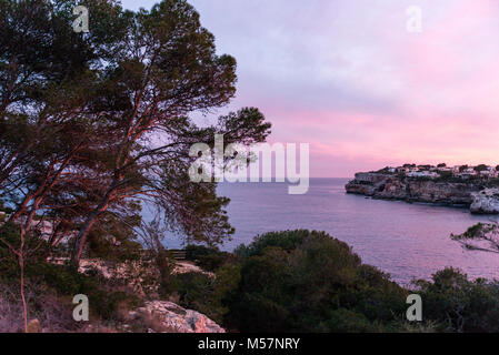 View of a colorful sunset over Cala Llombards in Mallorca, Spain. Stock Photo
