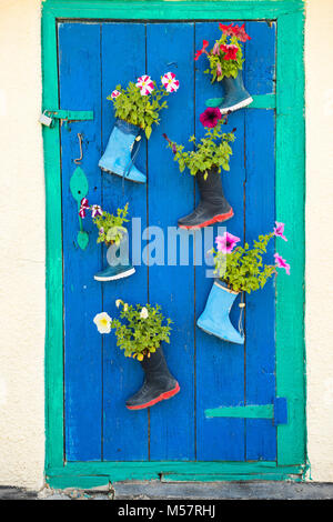 Old rubber boots with blooming flowers Stock Photo - Alamy