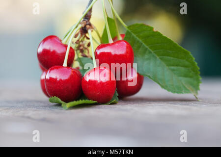 Red cherries berry close-up. Ripe fruit macro view photo. Selective focus, shallow depth of field. Beautiful bokeh background
