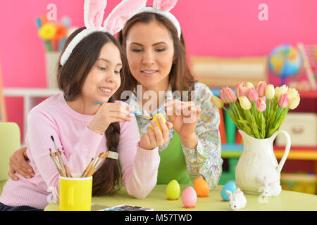 Mother and daughter colouring eggs  Stock Photo