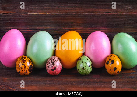 Multicolored easter eggs on a brown wooden table Stock Photo