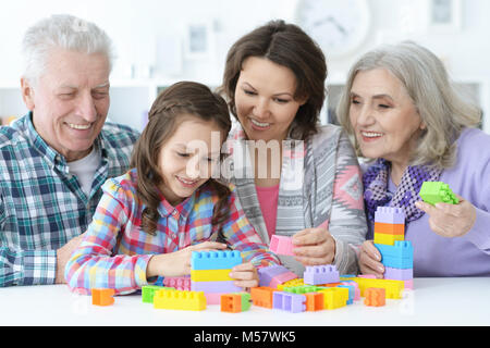 little cute girl with mother and grandparents playing  together Stock Photo