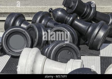 large plastic chess pieces lying on a plastic chessboard Stock Photo