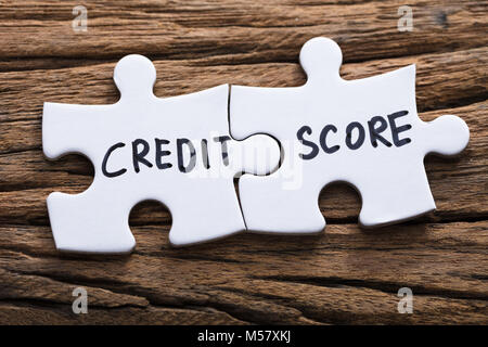 Closeup of connected credit score jigsaw pieces on wood Stock Photo