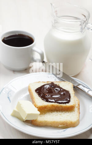 Breakfast with toasts, chocolate, butter, milk and coffee Stock Photo