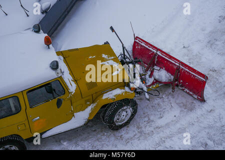 A Toyota Land Cruiser equiped with snow-plow cleans a road covered with fresh snow, Arolla, Val d'Herens, Valais, Swiss Stock Photo