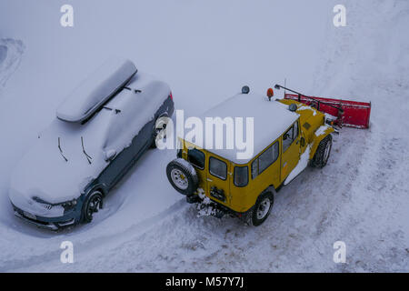 A Toyota Land Cruiser equiped with snow-plow cleans a road covered with fresh snow, Arolla, Val d'Herens, Valais, Swiss Stock Photo