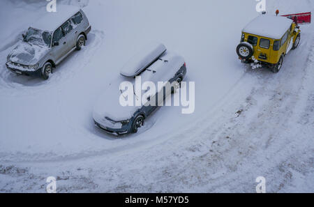 A Toyota Land Cruiser equiped with snow-plow cleans a road covered with fresh snow, Arolla, Val d'Herens, Valais, Swiss Stock Photo