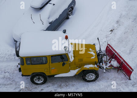 A Toyota Land Cruiser equiped with snow-plow cleans a road covered with fresh snow, Arolla, Val d'Herens, Valais, Swiss Stock Photo