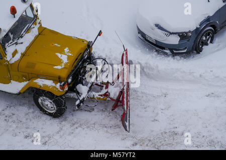 A Toyota Land Cruiser equiped with snow-plow cleans a road covered with fresh snow, Arolla, Val d'Herens, Valais, Swiss Stock Photo