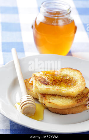 French toasts with honey on white plate Stock Photo