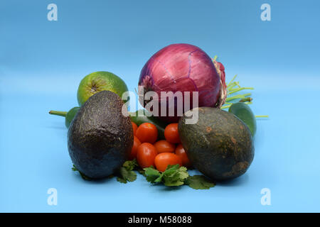 Guacamole ingredients, including avocado, jalapeno, cilantro, tomato, onion, and lime. Stock Photo
