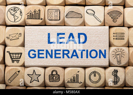 Full frame shot of lead generation text on wooden block surrounded by various computer icons Stock Photo