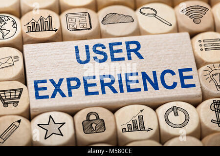 Full frame shot of user experience text on wooden block surrounded by various computer icons Stock Photo