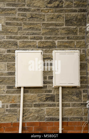 White plastic utilities boxes on a newly built home Stock Photo