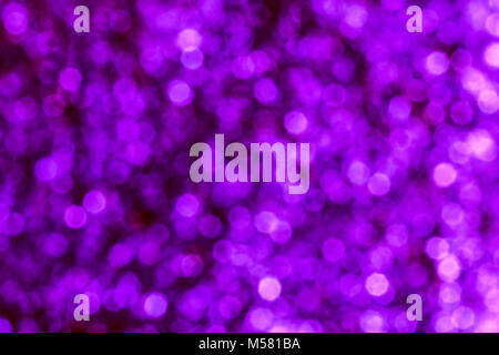 Colorful bokeh. The creative image of the bright holiday lights in blue and purple tones, blurred background. Stock Photo
